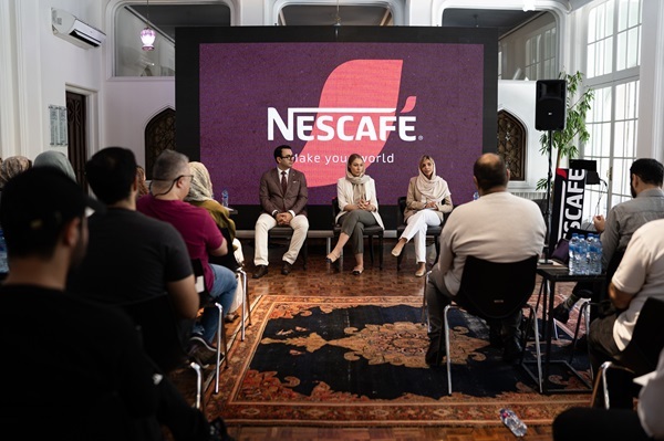 A group of people sitting in chairs in front of a large screen  AI-generated content may be incorrect.
